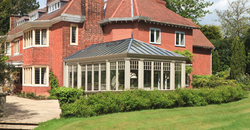 Pretty conservatory with folding doors provides a light filled sitting