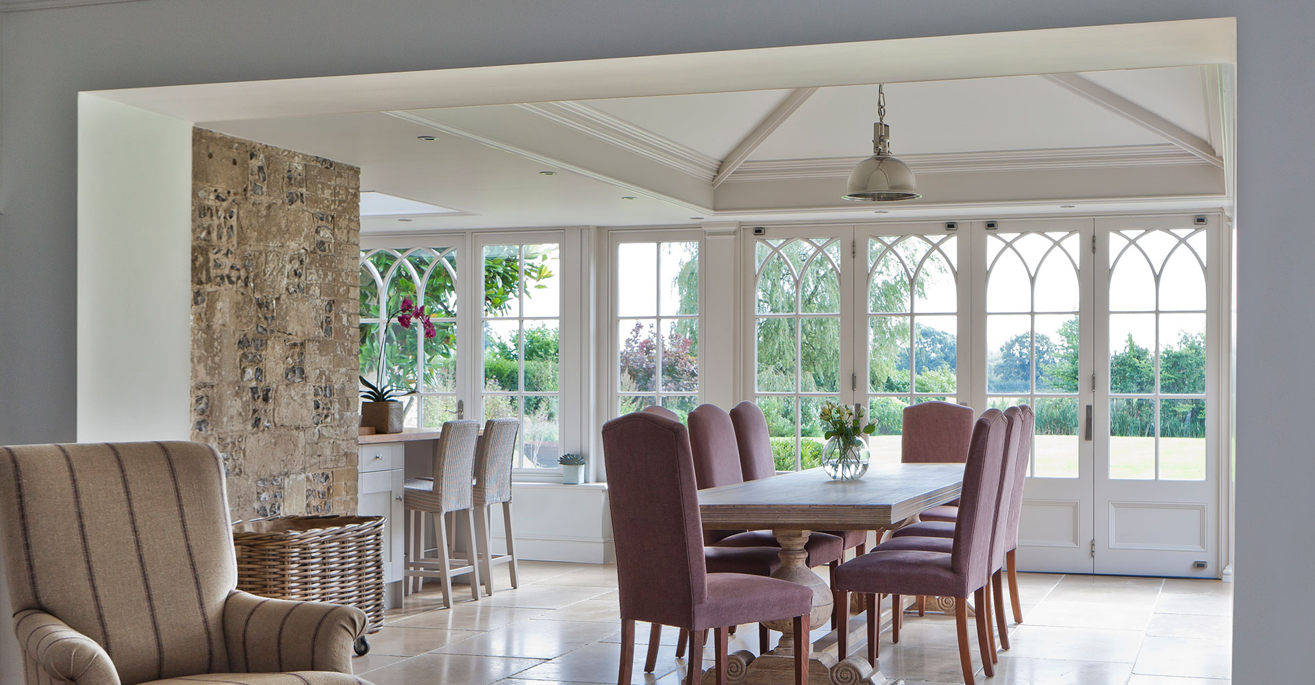 Example of a dining room orangery with a solid roof